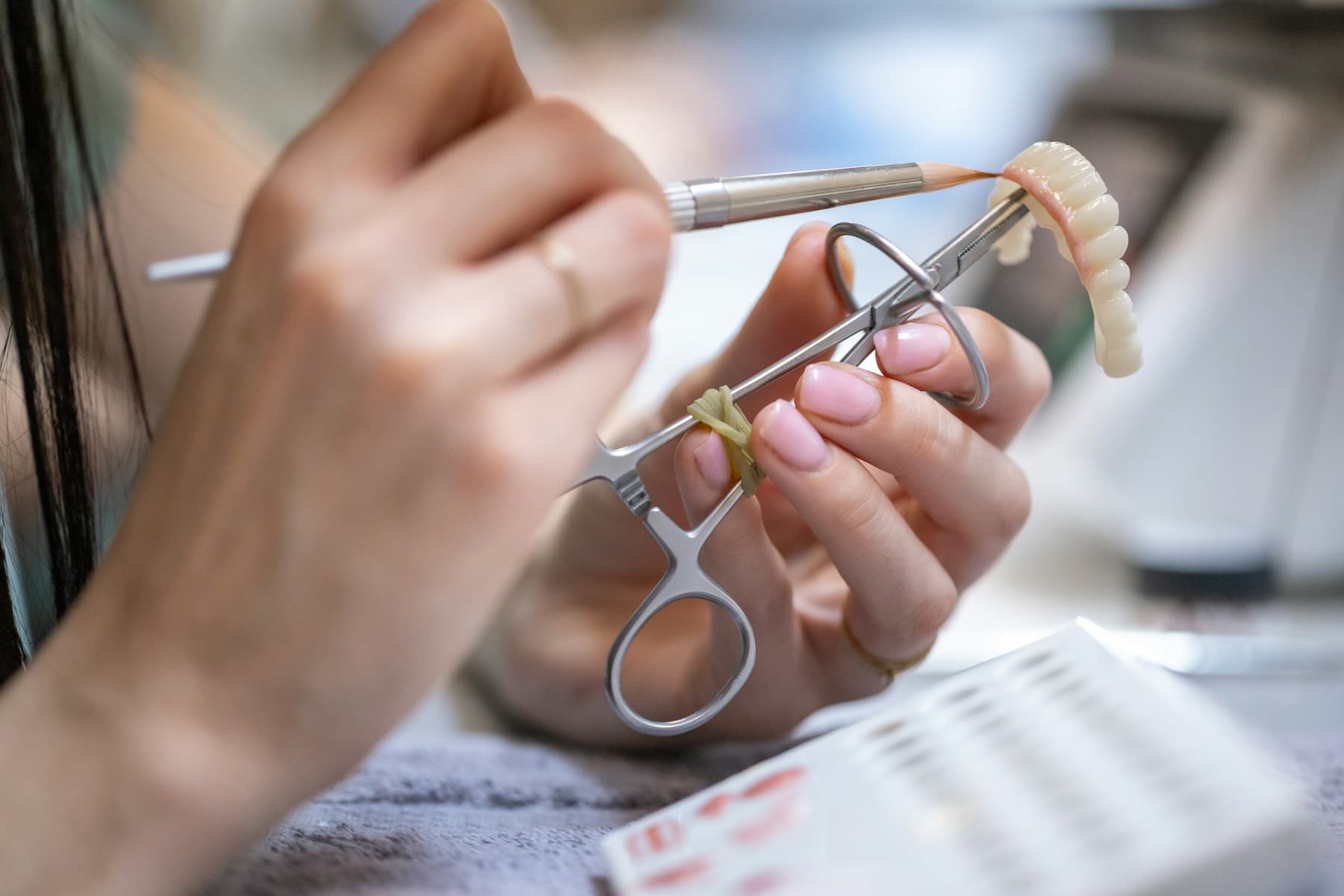 Close-up of dental laboratory work with precision clinical tools.